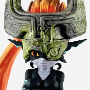 May include: A detailed figurine of a character from a video game. The figure features a black and white body with teal accents, a large headpiece, and orange hair-like flames. The figure is posed on a black base with teal geometric designs.