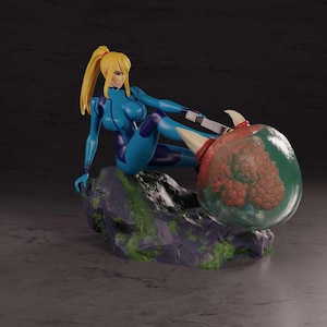 May include: A figurine of a character in a blue and purple bodysuit with a blonde ponytail, posed on a rock formation. The character is leaning against a large, transparent orb with a red and green interior. The base is a dark gray.