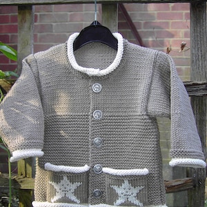May include: A gray knitted cardigan with white trim and star-shaped details. The cardigan has a button-up front and two pockets.