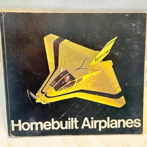 May include: A vintage book cover with a black background and a yellow airplane illustration. The airplane has black accents and the text "N180W" on the tail. The title "Homebuilt Airplanes" is printed in white.