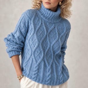May include: A light blue long-sleeve sweater featuring a prominent turtleneck collar and a textured cable knit pattern with vertical diamond shapes. The garment has ribbed cuffs and a ribbed hem, providing a structured fit around the waist and wrists.