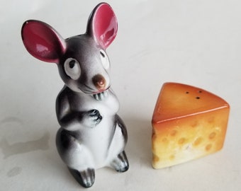 Anthropomorphic big eared mouse eating cheese wedge salt and pepper shaker set