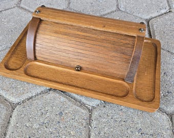 May include: A wooden box with a hinged lid and a tray. The box is made of light brown wood and has a natural finish. The tray is also made of wood and has a slightly darker finish.