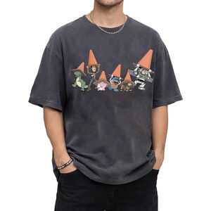 May include: Dark gray t-shirt featuring a graphic of Toy Story characters wearing orange traffic cones. The characters include Rex, Woody, Hamm, Mr. Potato Head, Slinky Dog, and Buzz Lightyear. The shirt has a vintage, washed look.