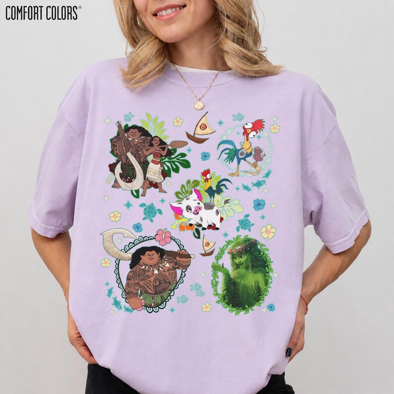 May include: A light purple Comfort Colors t-shirt featuring colorful cartoon graphics of characters from a popular animated movie. The graphics include characters, boats, and floral elements. The shirt is a relaxed fit.