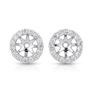 May include: A pair of silver-toned earring jackets featuring a circular halo design. Each piece is set with a ring of small, clear, round-cut stones surrounding a central open space with six prongs extending inward to hold a stud earring securely.