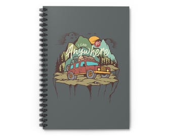 May include: Spiral-bound notebook with a gray cover. The cover features a colorful illustration of two off-road vehicles on a cliff, with mountains, trees, and a setting sun. The text "I CAN go Anywhere" is written in a stylized font.