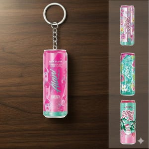 May include: A pink Alani Energy drink can keychain with a silver keyring and chain. The can features the text "Pink Slush" and "Energy" with a turquoise and white design. Additional Alani Energy drink cans are displayed.