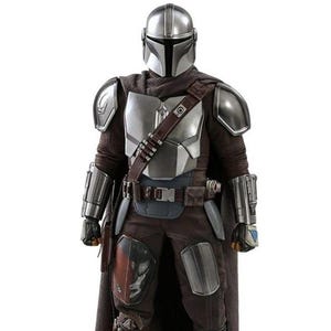 May include: A full-body shot of a Mandalorian costume. The costume features a silver helmet, chest armor, and shoulder pads. The outfit includes a brown cape, pants, and boots. A utility belt and a bandolier are also visible. The overall color scheme is silver, brown, and black.