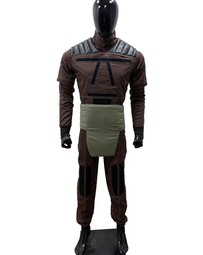 May include: A set of three ceramic mugs with a speckled, matte finish. The mugs are in shades of cream, light grey, and dark grey. Each mug has a simple, minimalist design and a rounded handle.