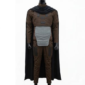 May include: A brown costume with a black cape. The costume includes a brown jacket, trousers, and a grey chest plate. The black cape drapes over the shoulders. The costume is displayed on a black mannequin.