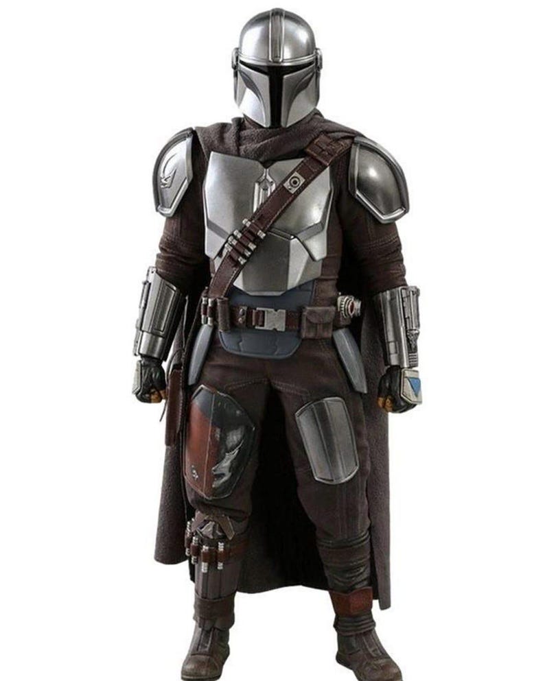 May include: A full-body shot of a Mandalorian costume. The costume features a silver helmet, chest armor, and shoulder pads. The outfit includes a brown cape, pants, and boots. A utility belt and a bandolier are also visible. The overall color scheme is silver, brown, and black.
