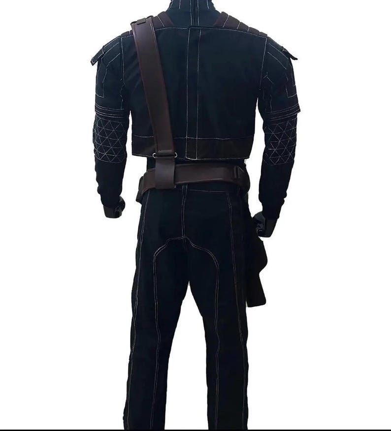 May include: Black outfit with white stitching, featuring a cropped jacket, pants, and a brown leather strap across the chest. The jacket has geometric patterns on the sleeves. The outfit includes a belt and a holster.