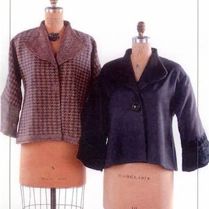 May include: Two jackets displayed on dress forms. One is a brown and tan houndstooth pattern with a notched collar. The other is a dark navy blue jacket with a single button closure and a wide collar. Both jackets have long sleeves.