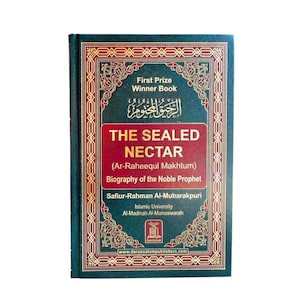 May include: A dark green hardback book titled The Sealed Nectar (Ar-Raheequl Makhtum) Biography of the Noble Prophet by Safiur-Rahman Al-Mubarakpuri. The cover features gold text, a red central panel, and intricate gold geometric border patterns.