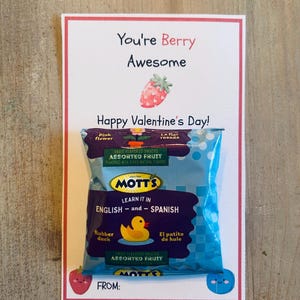 May include: A Valentine's Day card with the text "You're Berry Awesome" and "Happy Valentine's Day!" A bag of Mott's Assorted Fruit snacks is attached. The card has a strawberry illustration and a blue cartoon face.