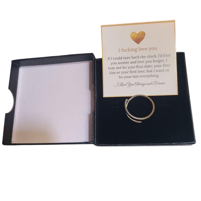 black gift box with engraved ring