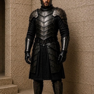 May include: A suit of dark, weathered metal armor featuring a segmented chest plate, shoulder pauldrons, gauntlets, and greaves. The armor is worn over a black quilted tunic and trousers, paired with a matching metal helmet and black leather gloves.