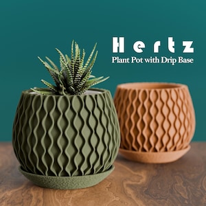 May include: Two decorative plant pots with drip bases. One is olive green and contains a succulent plant. The other is a light brown colour. The pots have a repeating wave pattern. The text "Hertz Plant Pot with Drip Base" is displayed.