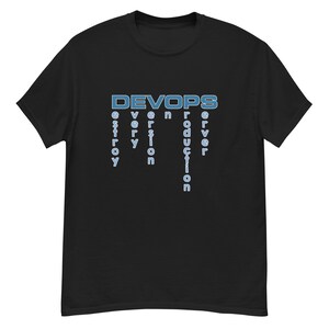 May include: Black t-shirt featuring the word "DEVOPS" in light blue, with the words "destroy", "every", "version", "production", and "server" stacked below in light blue. The shirt is made of a soft material.