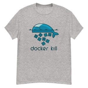 Könnte beinhalten: Hellgraues T-Shirt mit einem Design einer blauen Wal und dem Text "docker kill" in Türkis. Der Wal befindet sich über einer Gruppe blauer Quadrate. Das T-Shirt besteht aus weichem, bequemem Material.