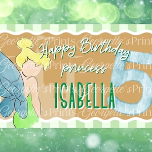 May include: A birthday card featuring a cartoon fairy with blonde hair and blue wings. The card says "Happy Birthday princess ISABELLA" with the number 5. The background is a light green with a bokeh effect.