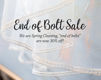 May include: A white sheer fabric with lace trim, with the text "End of Bolt Sale" and "We are Spring Cleaning, "end of bolts" are now 30% off!"
