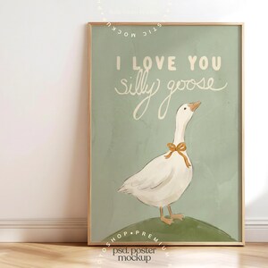 May include: A framed art print featuring a white goose with a yellow bow around its neck, standing on a green hill. The text "I LOVE YOU silly goose" is written in white script on a light green background.