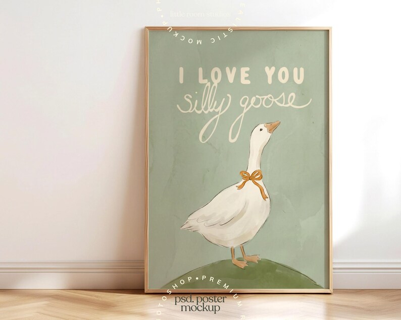 May include: A framed art print featuring a white goose with a yellow bow around its neck, standing on a green hill. The text "I LOVE YOU silly goose" is written in white script on a light green background.