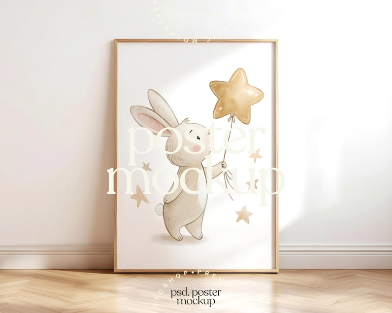 May include: A framed art print features a watercolor illustration of a bunny holding a gold star balloon. The bunny is light brown with long ears and a small tail. Several gold stars are scattered around the bunny. The print is in a wooden frame.