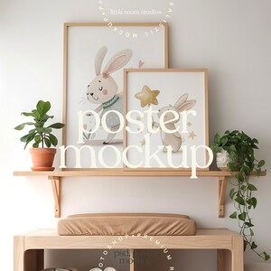 May include: Two framed bunny art prints with light wood frames, displayed on a wooden shelf. The prints feature watercolour illustrations of bunnies holding stars and flowers. A small potted plant and a larger plant are on the shelf. The word "POSTER MOCKUP" is displayed in large letters.