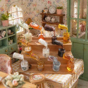 May include: Miniature bottles and glasses with liquids pouring into them. The scene is set in a dollhouse with a wooden table and shelves. The liquids are various colors, including white, orange, and brown.