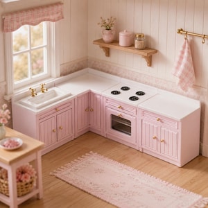 May include: A miniature dollhouse kitchen set featuring light pink cabinets with gold knobs, a white sink with gold faucets, a white stove with four black burners, a wooden wall shelf with a pink jar and glass jar, and a pink checkered curtain.