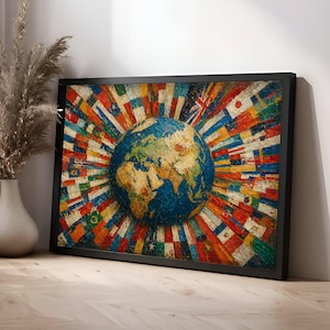 May include: A framed artwork featuring a textured globe at the center, surrounded by a burst of colorful flags. The flags represent various countries, radiating outwards from the globe. The artwork is set against a white wall and rests on a wooden surface.