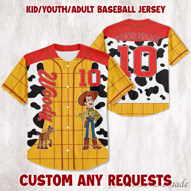 May include: Baseball jersey with a Woody design. The jersey is yellow with a red collar and sleeves. The front features the number 10, the name "Woody", and an image of Woody and a horse. The back has the number 10 and a cow print.