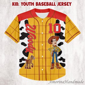 May include: Yellow, red, and white baseball jersey with a cartoon cowboy graphic. The jersey features the name "Woody" in red script, the number "10", and a cartoon image of a horse. The text "Kid, Youth Baseball Jersey" is at the top.