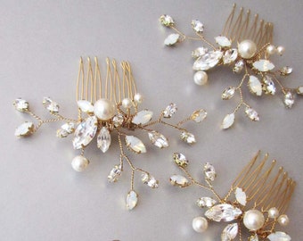 May include: Three gold hair combs with pearl and crystal embellishments and a pair of matching earrings. The combs have a delicate floral design with leaves and branches.