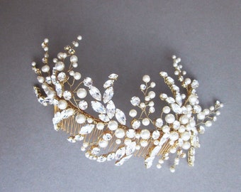 May include: A gold hair comb with a floral design featuring clear rhinestones and white pearls.