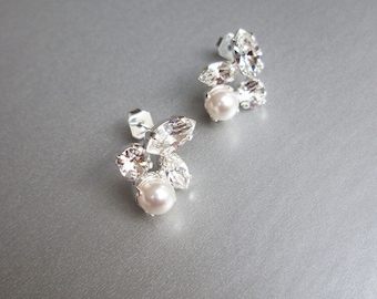 May include: A pair of silver earrings with a cluster of clear rhinestones and a single pearl on each earring.