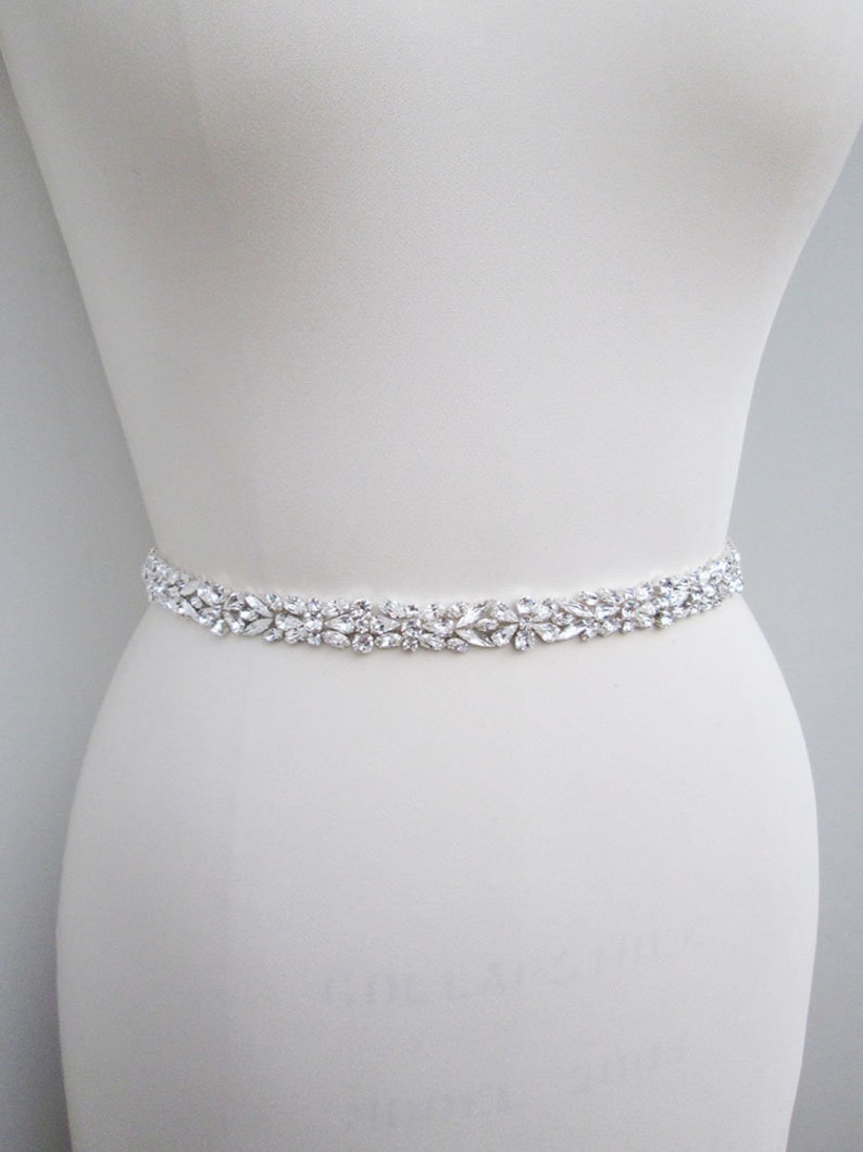 May include: A silver bridal belt with a row of clear crystal embellishments.