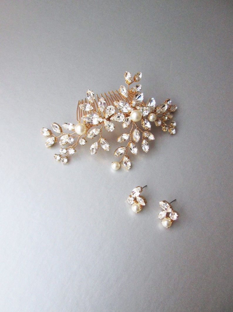 May include: Gold bridal hair comb with crystal and pearl embellishments. Matching earrings with crystal and pearl accents.