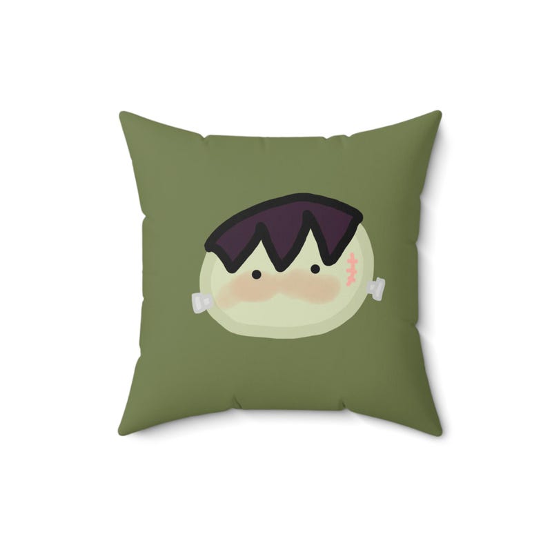 Square green pillow with a cute Frankenstein face