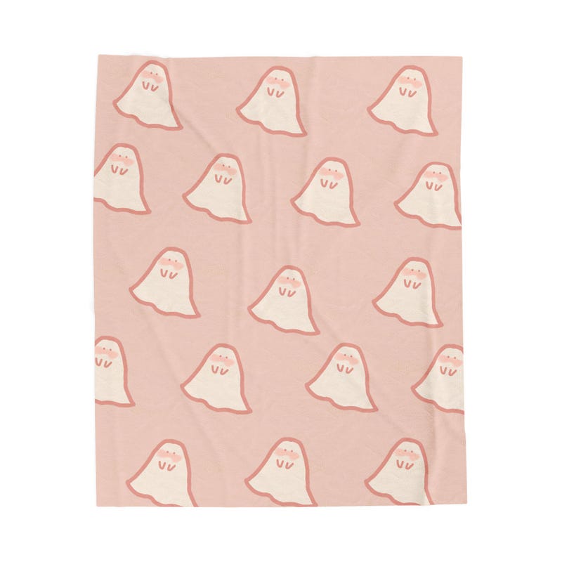 Pink blanket with smiling little ghosts