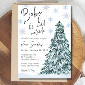 Op de afbeelding: Babyborrel uitnodiging met een winterthema. De uitnodiging bevat een aquarel illustratie van een kerstboom en sneeuwvlokken. De tekst luidt "Baby it's cold outside" en bevat de evenementdetails: datum, tijd en locatie.