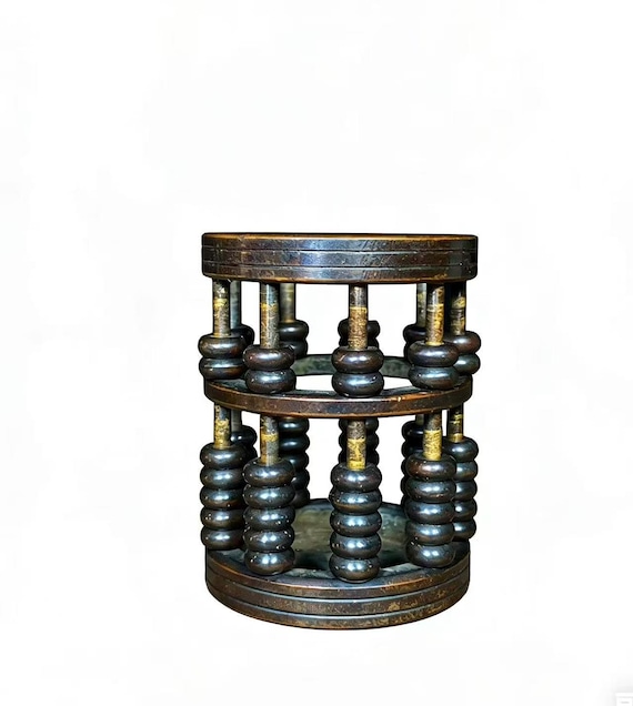 A fully functional bronze abacus repurposed as a pen holder — a conversation-starting desk object that straddles antique curiosity and actual utility.
