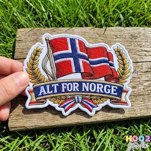 May include: Embroidered patch featuring the Norwegian flag with a red field, a blue Nordic cross, and white borders. The text "ALT FOR NORGE" is displayed on a blue banner. The patch is surrounded by a gold laurel wreath.
