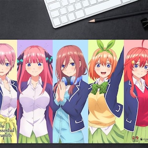 May include: A rectangular desk mat featuring five anime characters from The Quintessential Quintuplets, each in a separate vertical color panel. The characters wear school uniforms with blazers, skirts, and shirts. The text The Quintessential Quintuplets is printed in the bottom left corner.