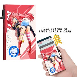 May include: A red and white cardholder featuring an anime character with pink hair and red boots. The cardholder has a black push button to eject cards and cash. Text on the cardholder reads "That Time I Got Reincarnated as a Slime."
