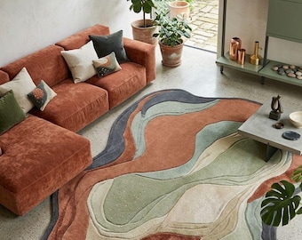 Tapis abstrait aux formes organiques, tapis tufté moderne aux tons naturels, décor vert sauge et beige terracotta