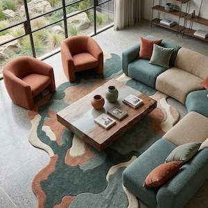 May include: A living room set featuring two burnt orange armchairs, a modular sofa in teal and beige, and a rectangular wooden coffee table with a resin inlay. An irregular, multi-colored area rug in teal, orange, and cream sits underneath.